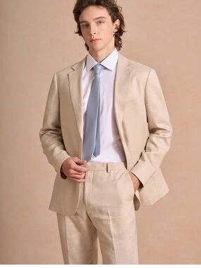 Men’s beige suit jacket with vest and tie all from azazie.